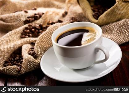 cup of black coffee and beans