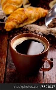 cup of black coffee and croissants