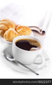 cup of black coffee, croissants and newspaper