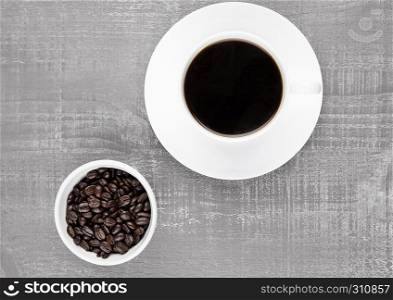 Cup of black coffee for breakfast with beans on coffee beans background
