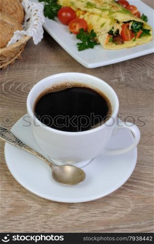 Cup of black coffee for breakfast with scrambled eggs