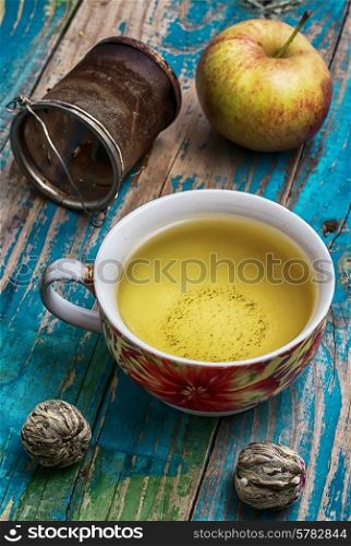 Cup of brewed tea,welding and ripe apple on new background