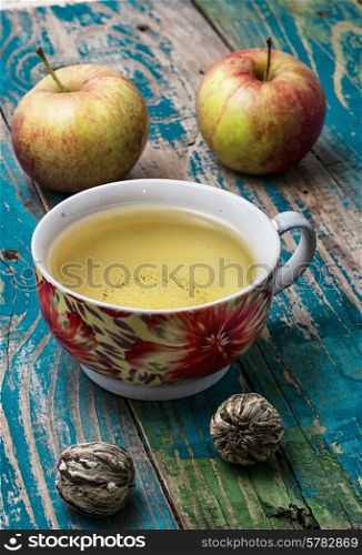 Cup of brewed tea.welding and ripe apple on new background. Cup of apple tea
