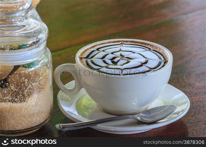 Cup of cappuccino coffee on wooden table