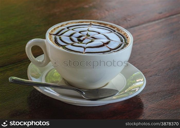 Cup of cappuccino coffee on wooden table
