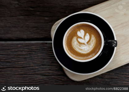 cup of cappuccino coffee on wooden table