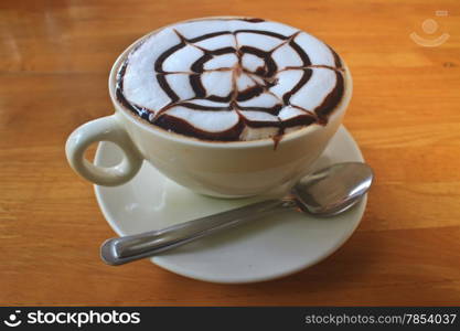 Cup of cappuccino coffee on wooden table