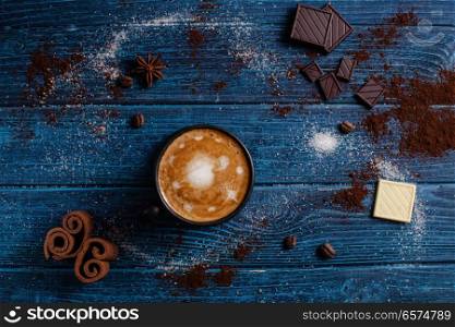Cup of cappuccino like part of universe. Cup of cappuccino like part of macrocosm, top view on the blue table