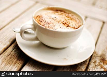 cup of cappuccino over wooden table