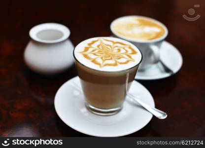 cup of cappuccino with brown and white foam on top