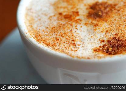 Cup of cappuccino with cinnamon close up