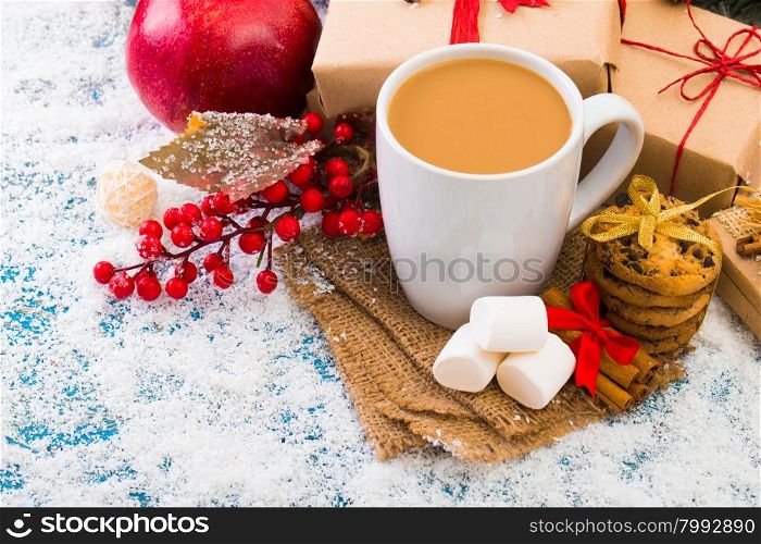 Cup of Christmas cappuccino on holiday background