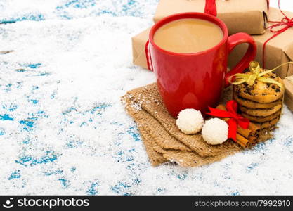 Cup of Christmas cappuccino on holiday background