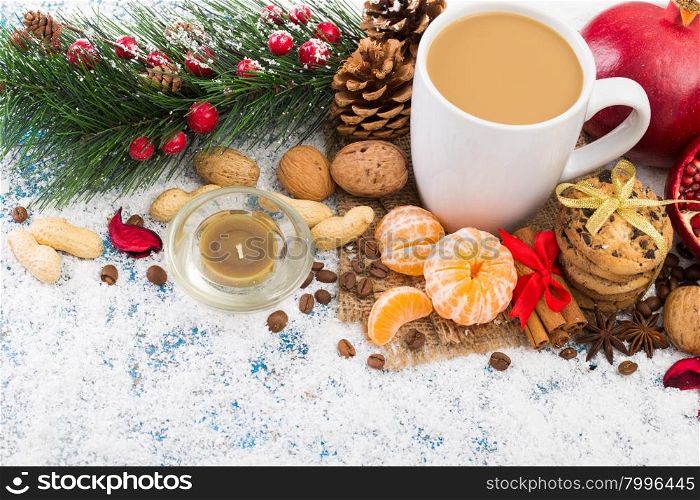 Cup of Christmas cappuccino on holiday background