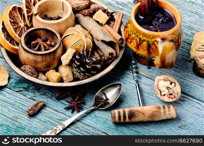 Cup of christmas mulled wine with spices on rustic table. Traditional drink on winter holiday