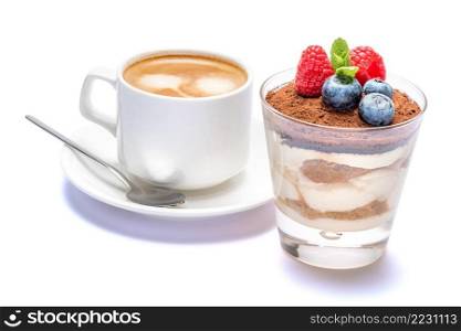 Cup of cofee and Classic italian tiramisu dessert with blueberries and raspberries in a glass isolated on a white background with clipping path. Cup of cofee and Classic tiramisu dessert with blueberries and raspberries in a glass isolated on a white background with clipping path