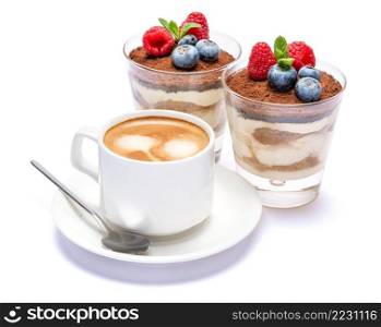 Cup of cofee and Classic italian tiramisu dessert with blueberries and raspberries in a glass isolated on a white background with clipping path. Cup of cofee and Classic tiramisu dessert with blueberries and raspberries in a glass isolated on a white background with clipping path