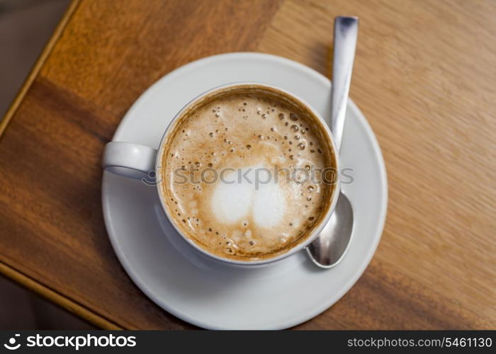 cup of cofee from top with heart on