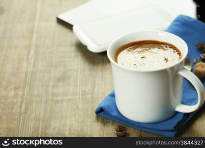 Cup of coffe with Digital tablet computer and smart phone on wooden table. Modern life and Business concept.