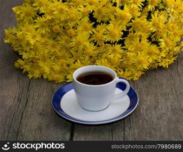 cup of coffee and beautiful bouquet of flowers, on a wooden table, a subject flowers and drinks