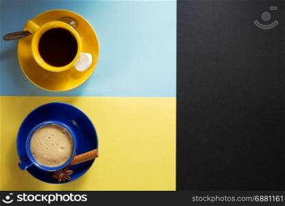 cup of coffee and cacao at colorful paper background