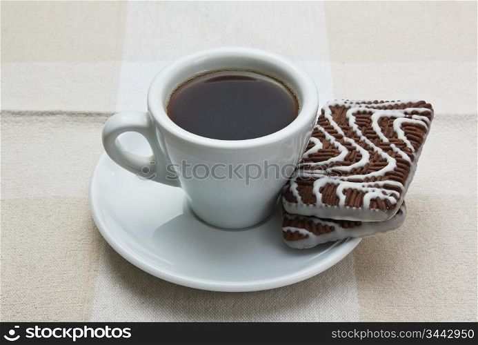 cup of coffee and chocolate chip cookies on table
