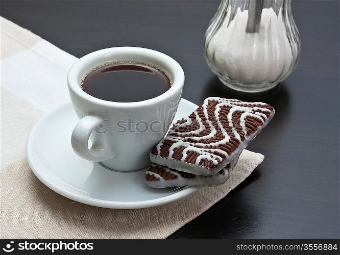 cup of coffee and chocolate chip cookies on table