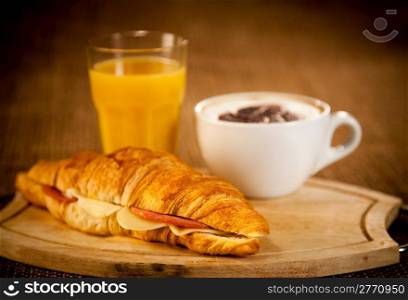 cup of coffee and croissant for breakfast