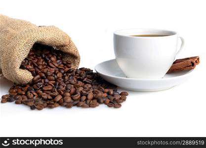 cup of coffee and dark brown roasted coffee beans