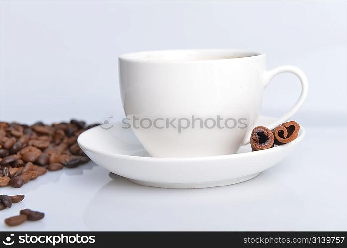 cup of coffee and dark brown roasted coffee beans