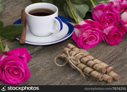 cup of coffee and from two parties red roses