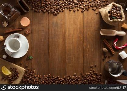 cup of coffee and ingredients on wooden background