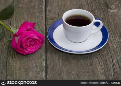 cup of coffee and lonely red rose on a table