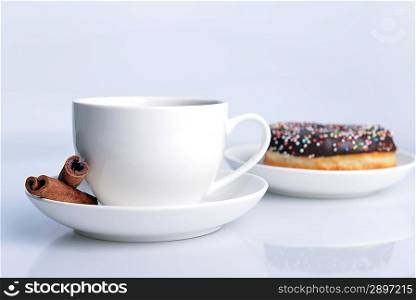 cup of coffee and sweet donut with chocolate icing