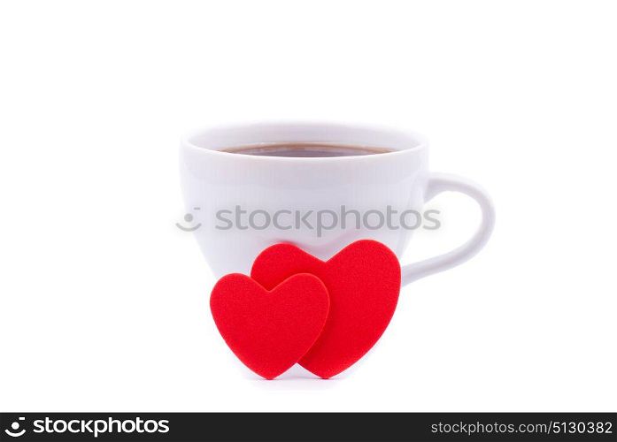 Cup of coffee and two red hearts on a white background.
