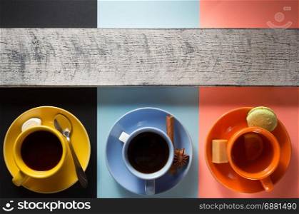 cup of coffee, cacao and tea at colorful paper background