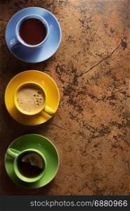 cup of coffee, cacao and tea on table background
