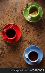 cup of coffee, cacao and tea on table background