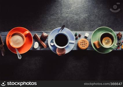 cup of coffee, cacao and tea on wooden background