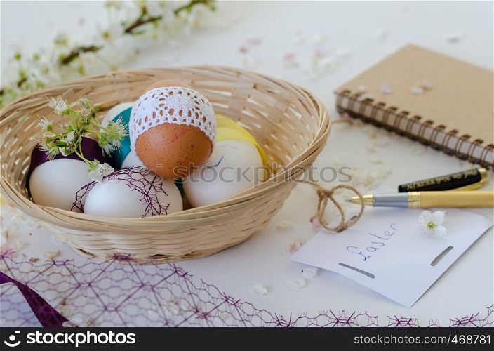 Cup of coffee , colorful fancy eggs and cherry blossom on white background. Easter concept