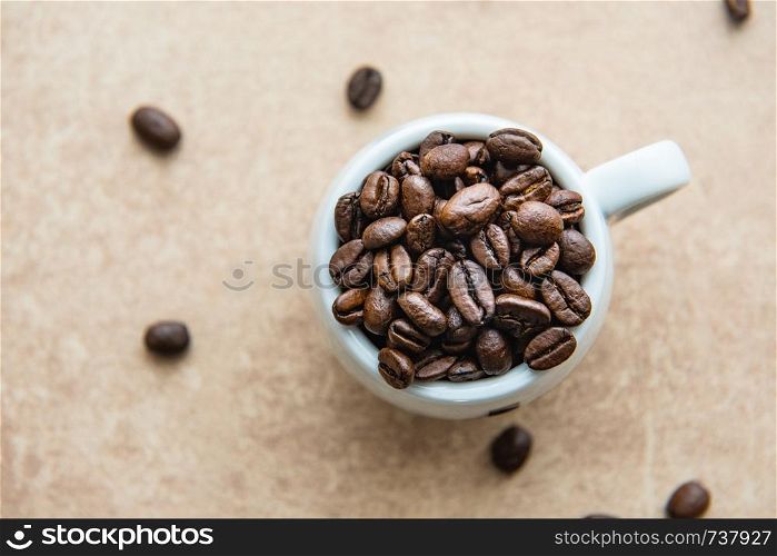 Cup of coffee full of coffee beans.. Cup of coffee full of coffee beans