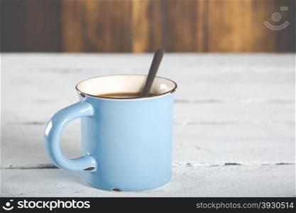 Cup of coffee in a blue vintage antique table