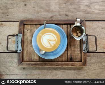 Cup of coffee in top view wooden table background.
