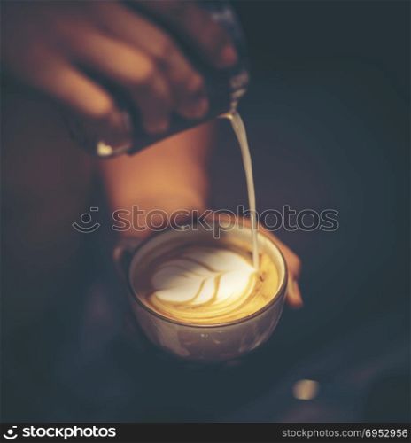 Cup of coffee latte art in coffee shop, vintage filter image
