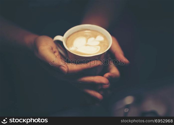 Cup of coffee latte art in coffee shop, vintage filter image