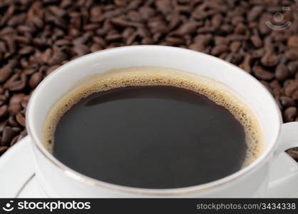 cup of coffee on a background coffee grains