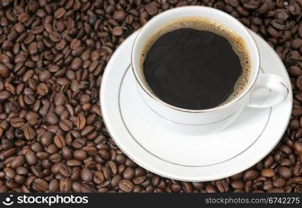 cup of coffee on a background coffee grains