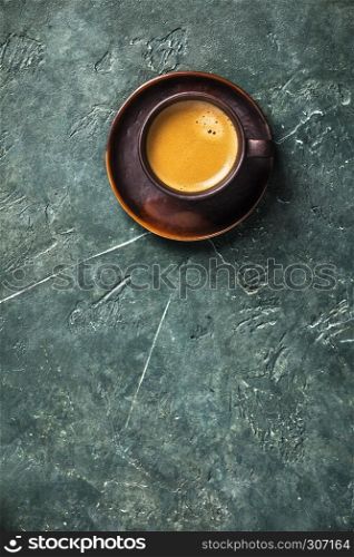 Cup of coffee on rustic background with space for text, flat lay. Cup of fresh coffee on rustic background
