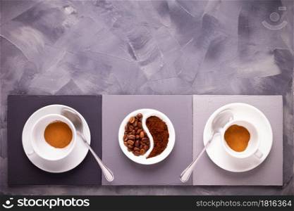 Cup of coffee on table. Coffee beans in plate and cup on abstract painted background texture