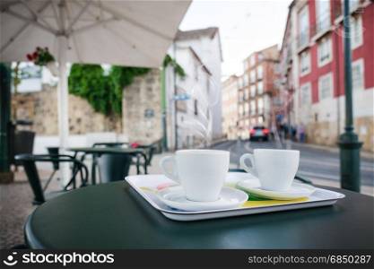 Cup of coffee on the street cafe table